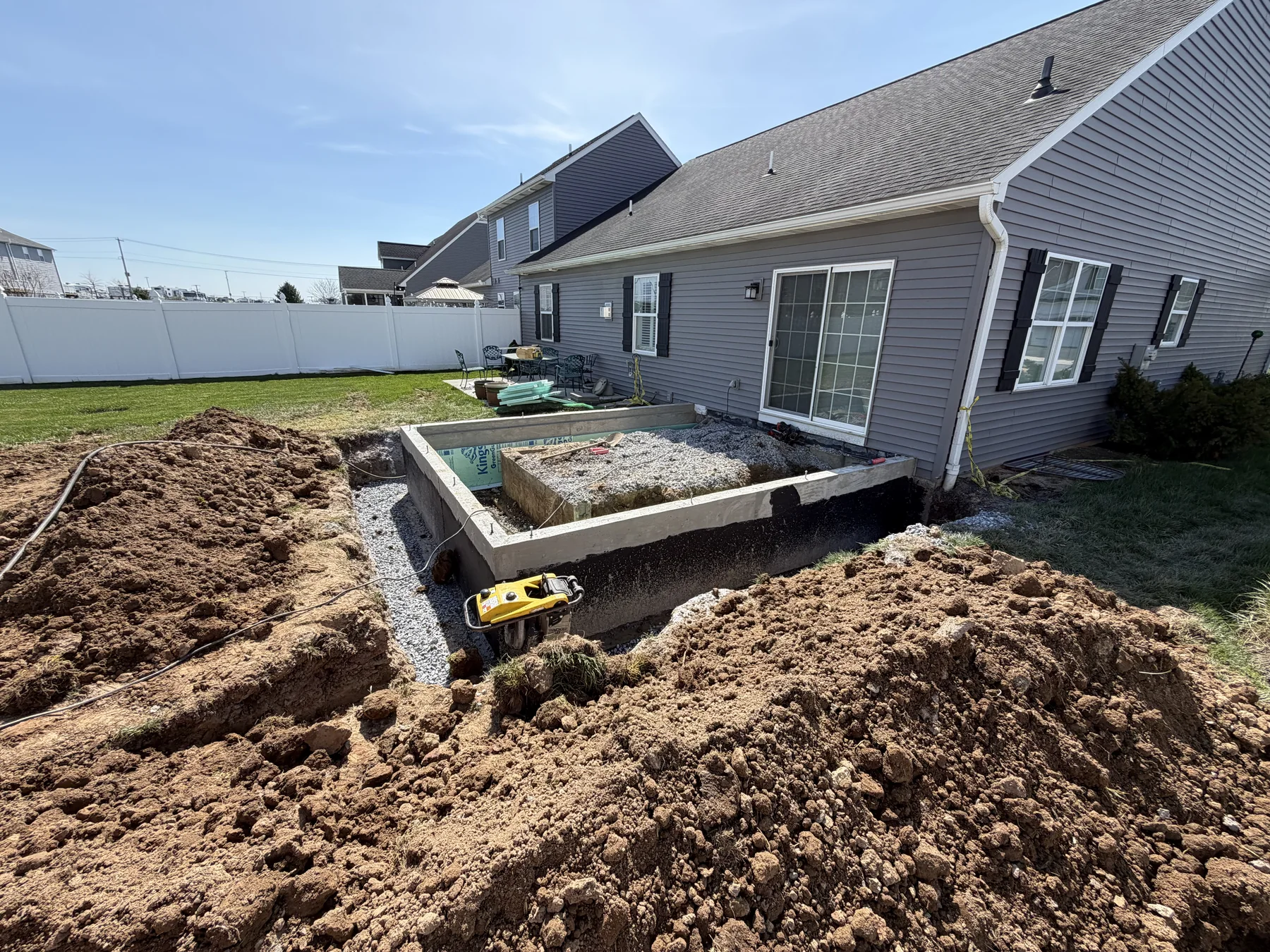 Concrete project preparation beside a home