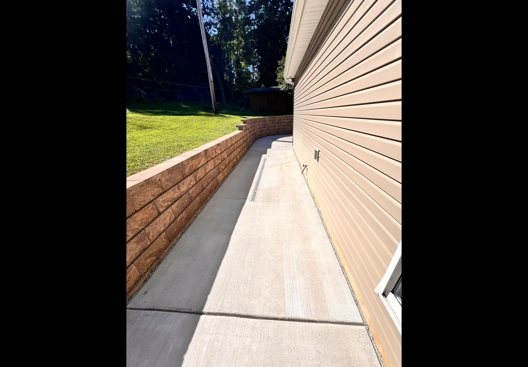 Finished concrete walkway beside a home