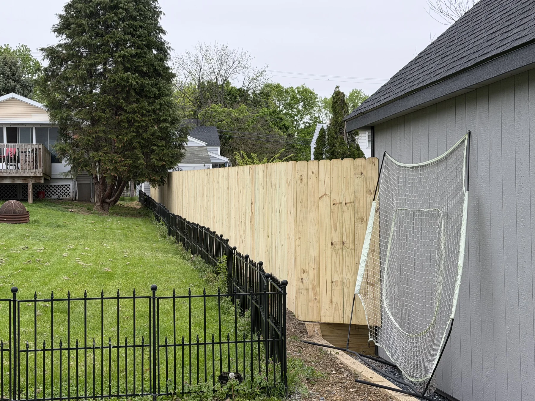 New wood privacy fence beside a property